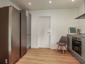 A kitchen with refrigerator and oven at Creek Lodge in Chacewater