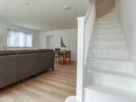 A living room with a sofa and dining table at Creek Lodge in Chacewater