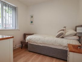 A bedroom with a bed and a chair at Creek Lodge in Chacewater