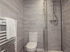 A bathroom with a shower and toilet at Creek Lodge in Chacewater