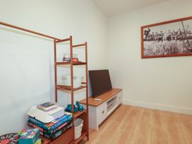A game room with shelves and television at Creek Lodge in Chacewater