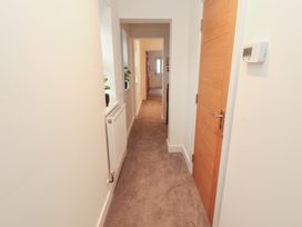 A hallway with a door and radiator at Little Plum Tree in Milnthorpe