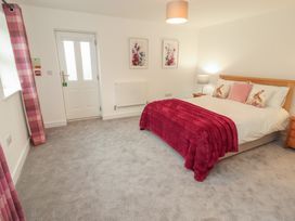 A bedroom with a bed and bedside table at Little Plum Tree in Milnthorpe