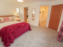 A bedroom with a bed and lamp at Little Plum Tree in Milnthorpe