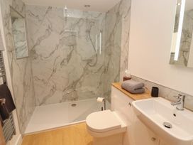 A bathroom with sink and shower at Little Plum Tree in Milnthorpe