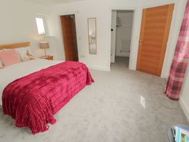 A bedroom with a bed and a nightstand at Little Plumtree in Milnthorpe