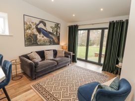A living room with a sofa and armchair at Blue heron lodge in Kirkby Stephen