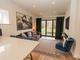 A living room with a sofa and rug at Blue heron lodge in Kirkby Stephen