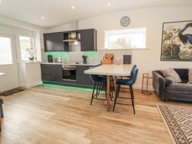 A kitchen with black cabinets and countertop at Blue heron lodge Kirkby Stephen