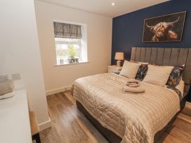 A bedroom with a bed and nightstand at Blue heron lodge in Kirkby Stephen