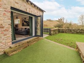 A living room with a sofa and television at Blue heron lodge in Kirkby Stephen