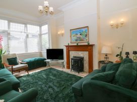 A living room with a sofa and television at Gwynfa in Old Colwyn