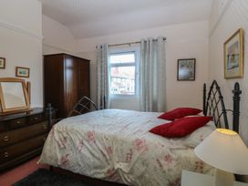 A bedroom with a bed and window at Gwynfa in Old Colwyn
