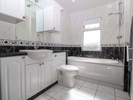 A bathroom with a sink, toilet, and bathtub at Gwynfa, Old Colwyn