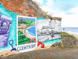 A mural depicting Colwyn Bay with a coastal view and other elements