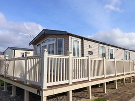A caravan with a deck and railings at Caravan B14 Beechrise in Filey