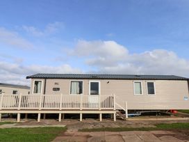 A caravan with decking and steps at Caravan B14 Beechrise Filey