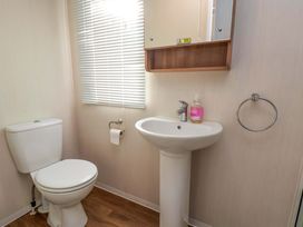 A bathroom with a toilet and sink at Caravan B14 Beechrise in Filey