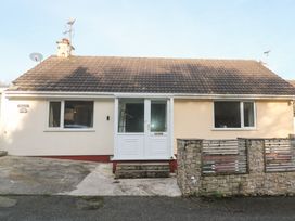 A house with a front door and windows at Piskies Magic Home