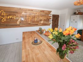 A kitchen with a wooden counter and decorative lighting at Piskies Magic Home 