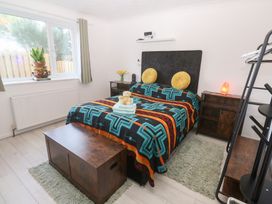 A bedroom with a bed and window at Piskies Magic Home