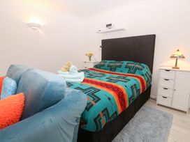 A bedroom with a bed and bedside table at Piskies Magic Home