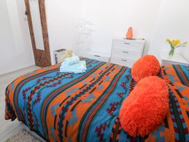 A bedroom with a bed and towels at Piskies Magic Home