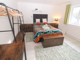 A bedroom with a bed and nightstand at Piskies Magic Home