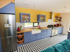 A kitchen with cabinets and appliances at The Cottage in Leenane, County Galway
