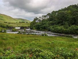 A landscape with a river and waterfall at The Cottage in Leenane, County Galway