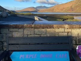 A bench with a sign by the water at The Cottage in Leenane, County Galway