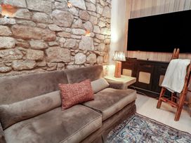A living room with a sofa and television at Hanowen House, Dungloe, County Donegal