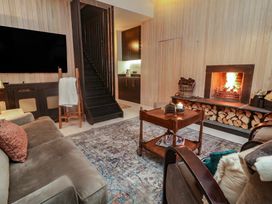 A living room with a fireplace and sofa at Hanowen House, Dungloe, County Donegal