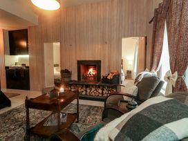A living room with a fireplace and sofa at Hanowen House in Dungloe, County Donegal