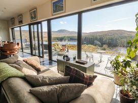 A living room with large windows overlooking a landscape at Hanowen House in Dungloe, County Donegal