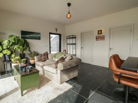 A living room with a sofa and a table at Hanowen House Dungloe, County Donegal