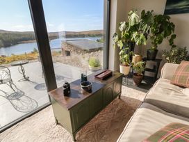 A living room with a coffee table and plants at Hanowen House in Dungloe, County Donegal