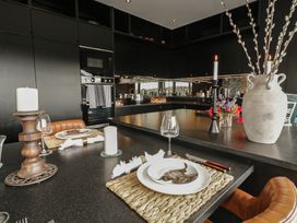 A kitchen with a dining setup and floral arrangement at Hanowen House, Dungloe, County Donegal