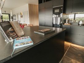 A kitchen with a cookbooks and modern appliances at Hanowen House in Dungloe, County Donegal