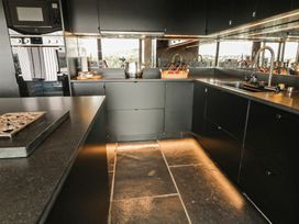 A kitchen with cabinets, sink, and stove at Hanowen House Dungloe, County Donegal