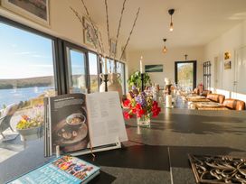 A dining room with a view of a lake at Hanowen House Dungloe, County Donegal