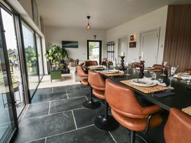 A dining room with a large table set for meals at Hanowen House Dungloe, County Donegal