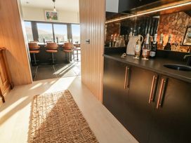 A kitchen with a bar counter and stools at Hanowen House, Dungloe, County Donegal
