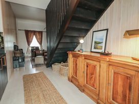 A hallway with a staircase and furniture at Hanowen House in Dungloe, County Donegal