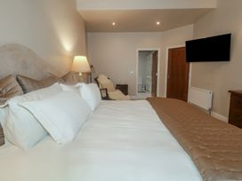 A bedroom with a bed and television at Hanowen House Dungloe, County Donegal