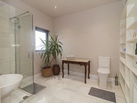 A bathroom with a shower, toilet, and a table at Hanowen House, Dungloe, County Donegal