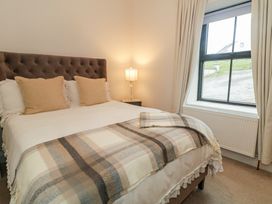 A bedroom with a bed and bedside lamp at Hanowen House in Dungloe, County Donegal