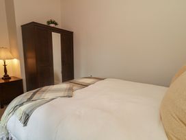 A bedroom with a bed and wardrobe at Hanowen House, Dungloe, County Donegal