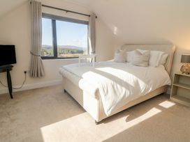 A bedroom with a bed and television at Hanowen House, Dungloe, County Donegal