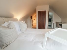 A bedroom with a bed and desk at Hanowen House, Dungloe, County Donegal